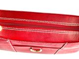 a red purse that is sitting on a white surface