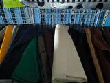 many different colored shirts hanging on a rack in a store