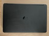a black laptop sitting on a wooden table