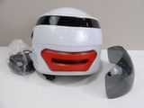 a white helmet with a red face and a gray helmet