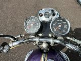 a close up of a motorcycle with a speedometer and gauges on it
