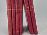 six red books stacked on top of each other on a white surface
