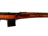 une image représentant un fusil au canon en bois sur fond blanc
