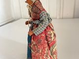 a figurine of a woman in a dress and hat