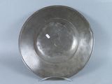 a silver plate that is sitting on a stand