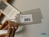 a picture of a purse with a tag attached to it