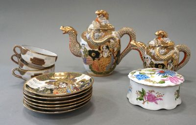 a lot of teapots and cups on the table