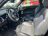 the interior of a small car with a steering wheel and dashboard