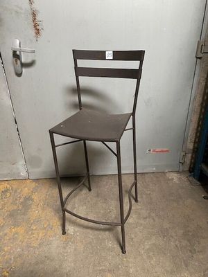 a metal chair that is sitting in the corner of a room