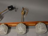 three lamps and a lamp shade on a wooden pole