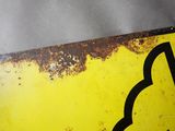 a yellow sign with a black b on it
