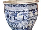 a large blue and white vase with a picture of people on it