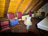 several chairs and a table in a room with a wooden ceiling