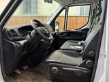 a white van with a black seat and a black suitcase in the back