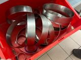 a person opening a red box with a bunch of pans inside of it