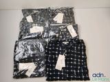 four men ' s pajamas are wrapped in plastic bags on a table