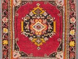 a close up of a red rug with a floral design on it