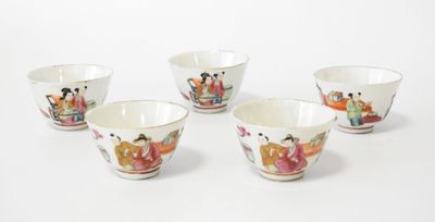 four small bowls with asian designs on them sitting on a white surface