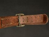 leather watch strap with a buckle on a black background