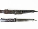 two different types of knives on a white surface