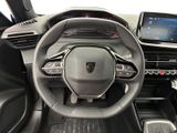 the interior of a car with a steering wheel and dashboard controls