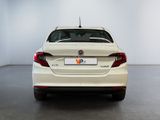 the rear end of a white car in a white room