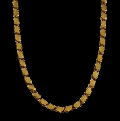 a close up of a gold necklace on a black background