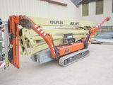 a crane that is sitting on the ground in front of a building