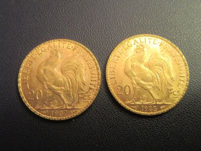 a close up of two gold coins on a black surface
