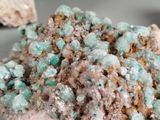 a close up of a piece of rock with green crystals on it
