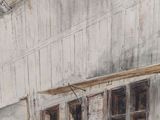 a painting of an old building with a horse in the doorway