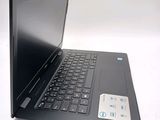 a black laptop computer sitting on a white surface