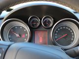dashboard of a car with gauges, speedometers, and steering wheel
