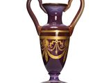 a purple vase with a gold decoration on it