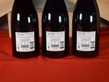 three bottles of wine sitting next to each other on a table