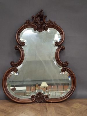 an image of a mirror sitting on top of a wooden table