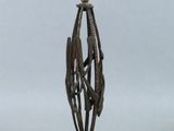 an antique brass candle holder with a bird on top of it