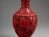 a red vase with a picture of a boat on it