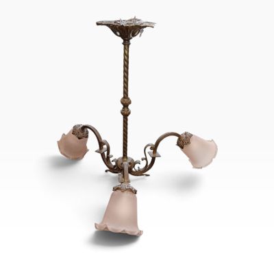 an antique brass chandelier with pink glass shades
