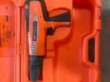 an orange box with a hammer in it on the floor
