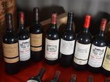 several bottles of wine are lined up on a table
