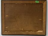an old picture of a brown frame with a green sticker on it