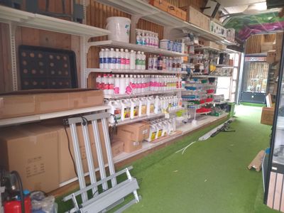 a shelf of paint and other supplies in a store