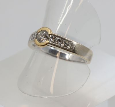 a close up of a ring with a diamond on it