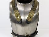 a close up of a silver and gold armor on a white background