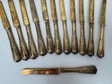 eight knives and a knife on a white surface