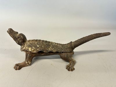 an old bronze figurine of a dog with a collar and tail