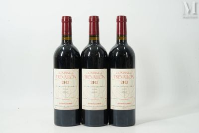 trois bouteilles de vin rouge posées côte à côte sur une table