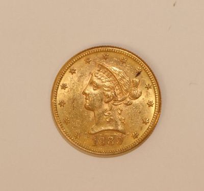 a close up of a gold coin on a white surface