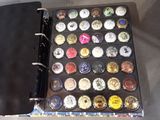 a black binder with a bunch of different colored buttons on it